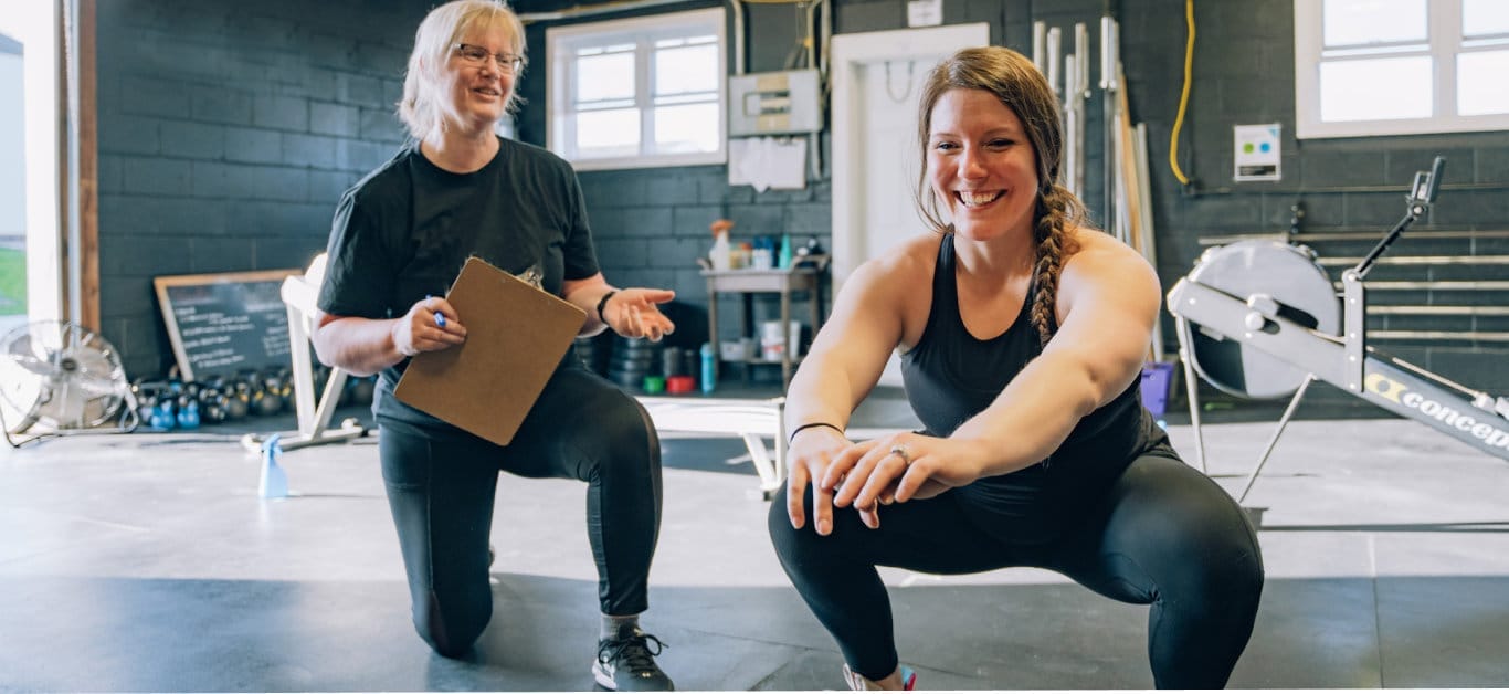 woman training with her personal coach at CrossFit PTC